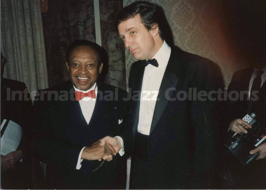 3 1/2 x 5 inch photograph. Lionel Hampton shakes hands with Donald Trump