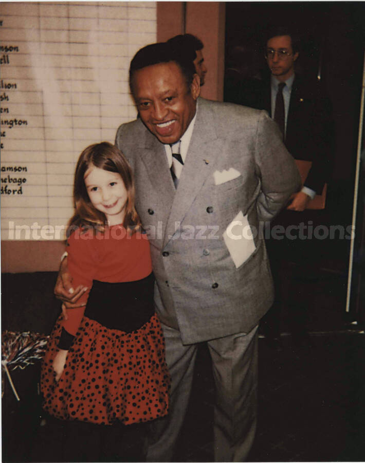 10 x 8 inch photograph. Lionel Hampton with a girl. Accompanying this photograph is a paper portfolio with a dedication to Lionel Hampton from Liz, Jenny, and Paul Edward Gussman