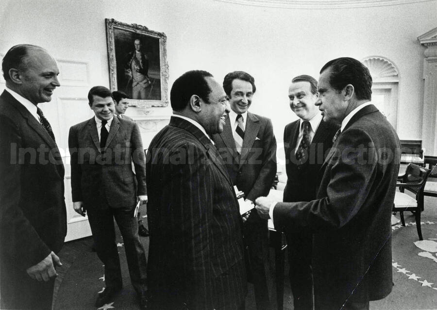 8 x 10 inch photograph. Lionel Hampton with President Richard Nixon. Present are Bill Titone and presidential aides, in the White House, Washington D.C.