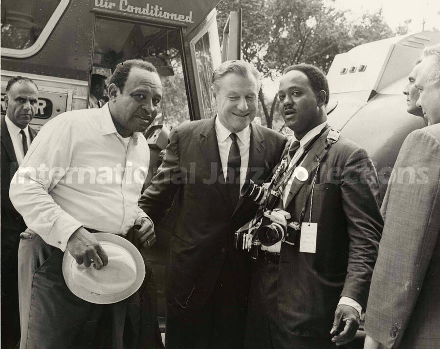 8 x 10 inch photograph. Lionel Hampton with Governor of New York, Nelson Rockefeller and photographer Bertrand Miles. Handwritten on the back of the photograph: Photo by Sonnie Simmons, Chicago, IL, Alto-sax, organ