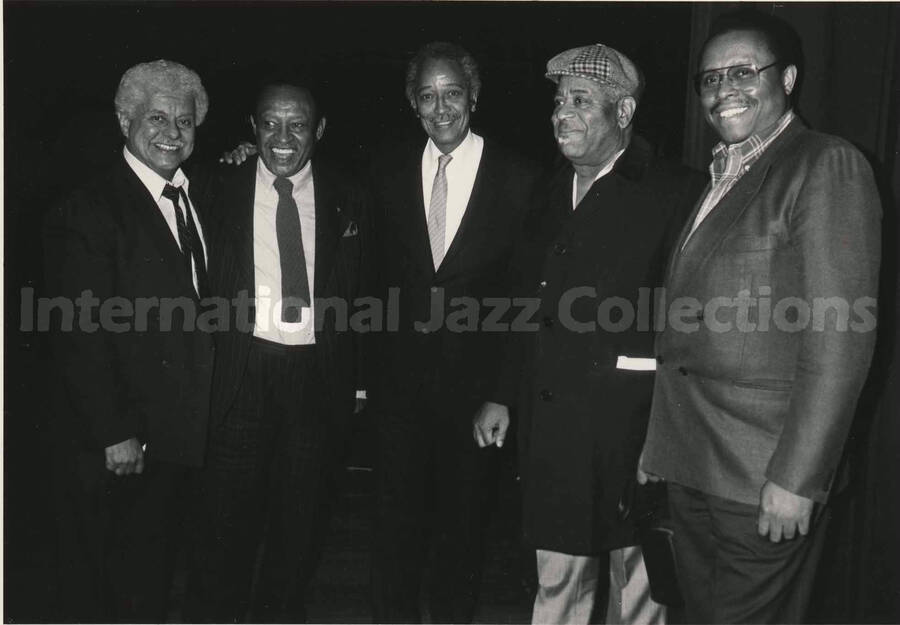 5 x 7 inch photograph. Tito Puente, Lionel Hampton, David Norman Dinkins, Dizzy Gillespie, and an unidentified man
