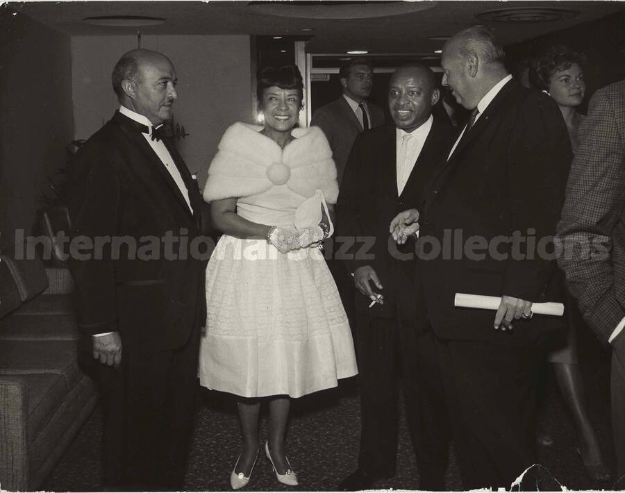 8 x 10 inch photograph. Gladys and Lionel Hampton with unidentified men
