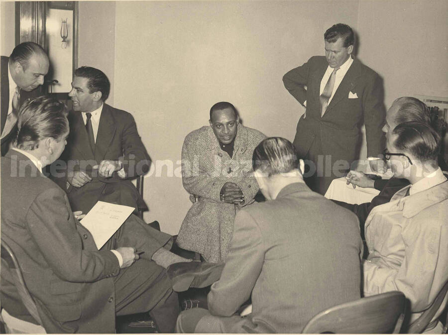 7 x 9 inch photograph. Lionel Hampton with unidentified men [abroad?]
