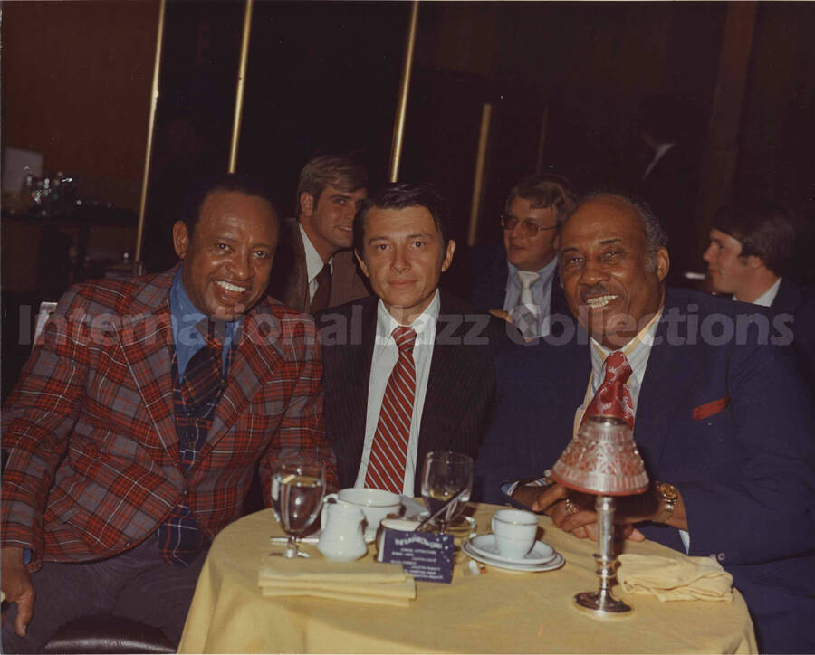 8 x 10 inch photograph. Lionel Hampton with two unidentified men at the Rainbow Grill restaurant