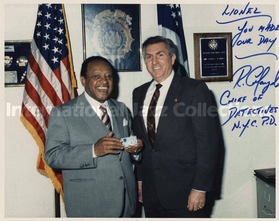 8 x 10 inch signed photograph. Lionel Hampton with chief of detectives, Robert Colangelo, during his visit to the New York City Police Department