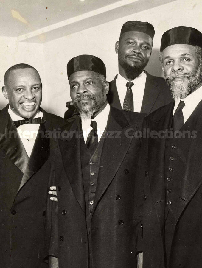 10 x 8 inch photograph. Lionel Hampton with three unidentified men