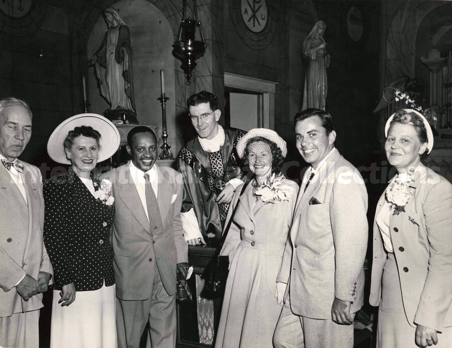8 x 10 inch photograph. Lionel Hampton with unidentified persons, including a priest, inside a church