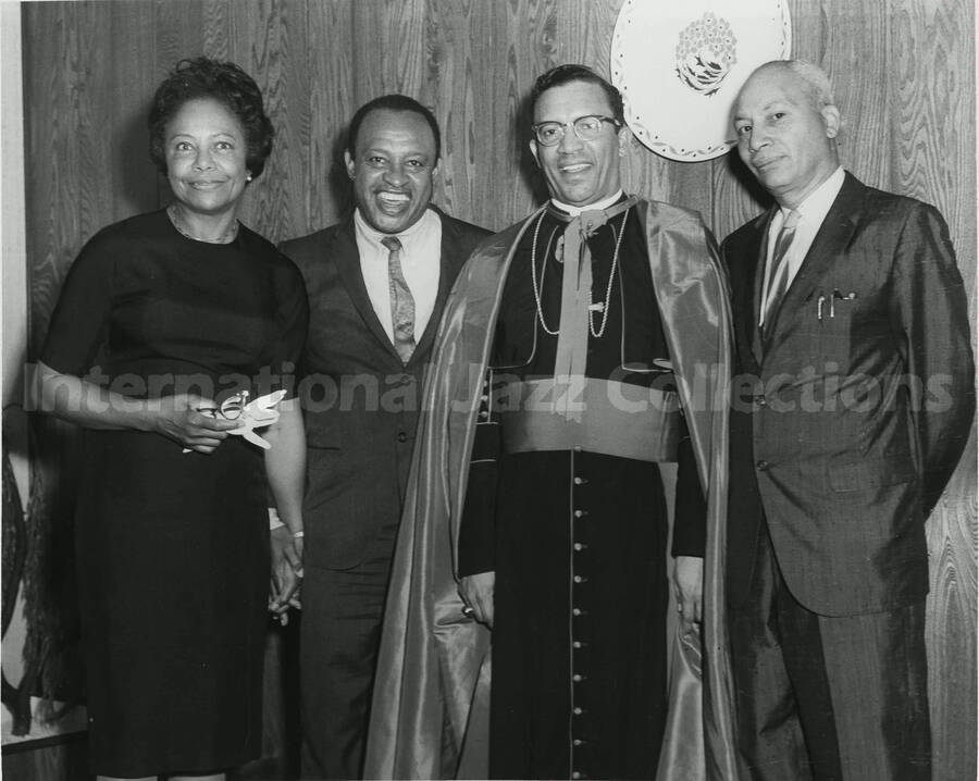 8 x 10 inch photograph. Lionel Hampton with unidentified persons including a religious