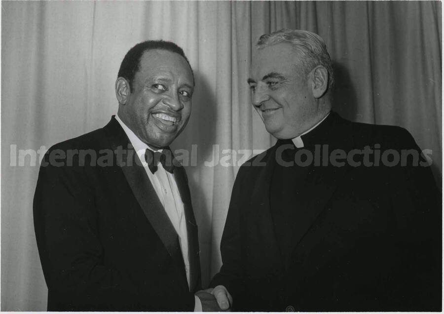5 x 7 inch photograph. Lionel Hampton with unidentified man representing an unidentified church
