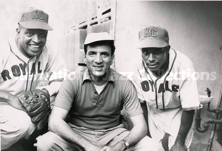 5 x 7 inch photograph. Lionel Hampton in a Kansas City Royals uniform poses with unidentified player and a man