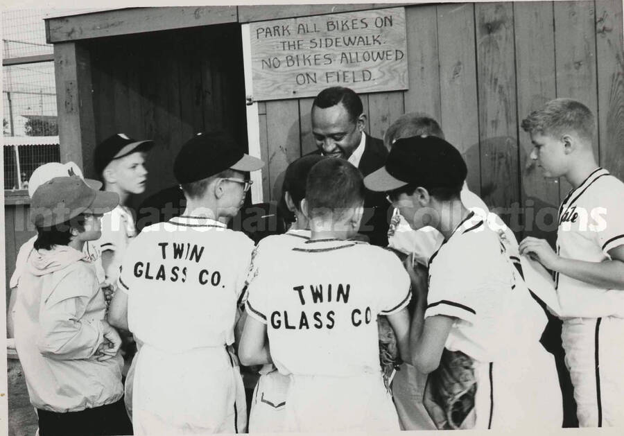 5 x 7 inch photograph. Lionel Hampton gives autographs to the boys of the Margate Little League Baseball Team, New Jersey