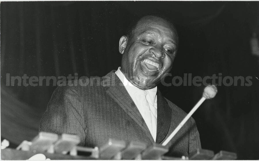6 x 10 inch photograph. Lionel Hampton playing the vibraphone. Handwritten on the back of the photograph: Hiroshi [Gno?]