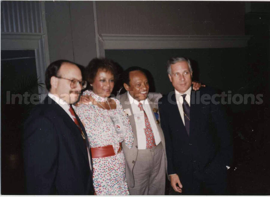 3 1/2 x 5 inch photograph. Lionel Hampton posing with unidentified persons, on the occasion of the Republican National Convention, in New Orleans, LA