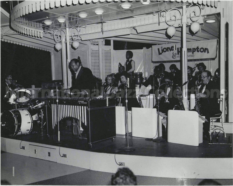 8 x 10 inch photograph. Lionel Hampton performing on the vibraphone with band [at Disneyland?]. Handwritten on the back of the photograph: Walt Disney World