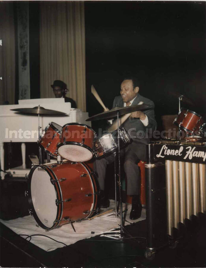 5 1/4 x 4 1/4 inch Polaroid photograph. Lionel Hampton playing the drums