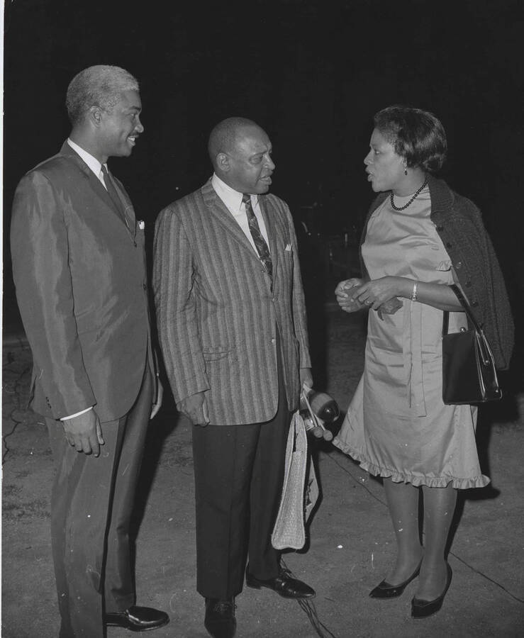 10 x 8 inch photograph. Lionel Hampton with Government Secretary and  Mrs. King. Hampton is holding a bag that reads: Virgin Islands