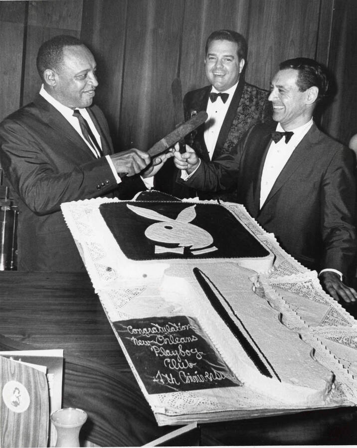 10 x 8 inch photograph. Lionel Hampton with two unidentified men at a table with a cake shaped like a key. Note next to the cake reads: Congratulations New Orleans Playboy Club 4th Anniversary