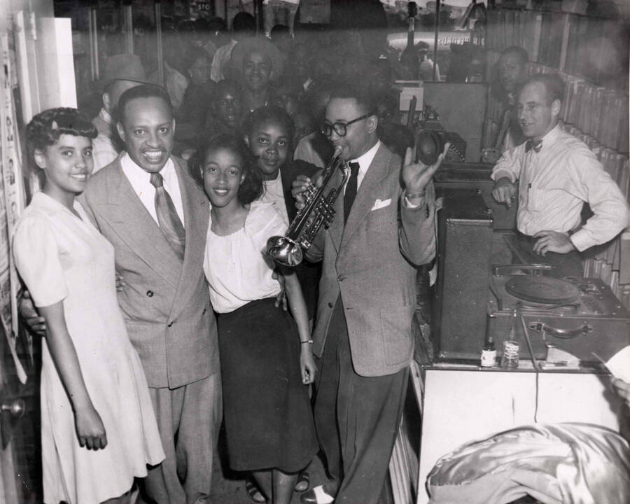 8 x 10 inch photograph. Lionel Hampton and [Dizzy Gillespie?] with unidentified persons, [in a record store]