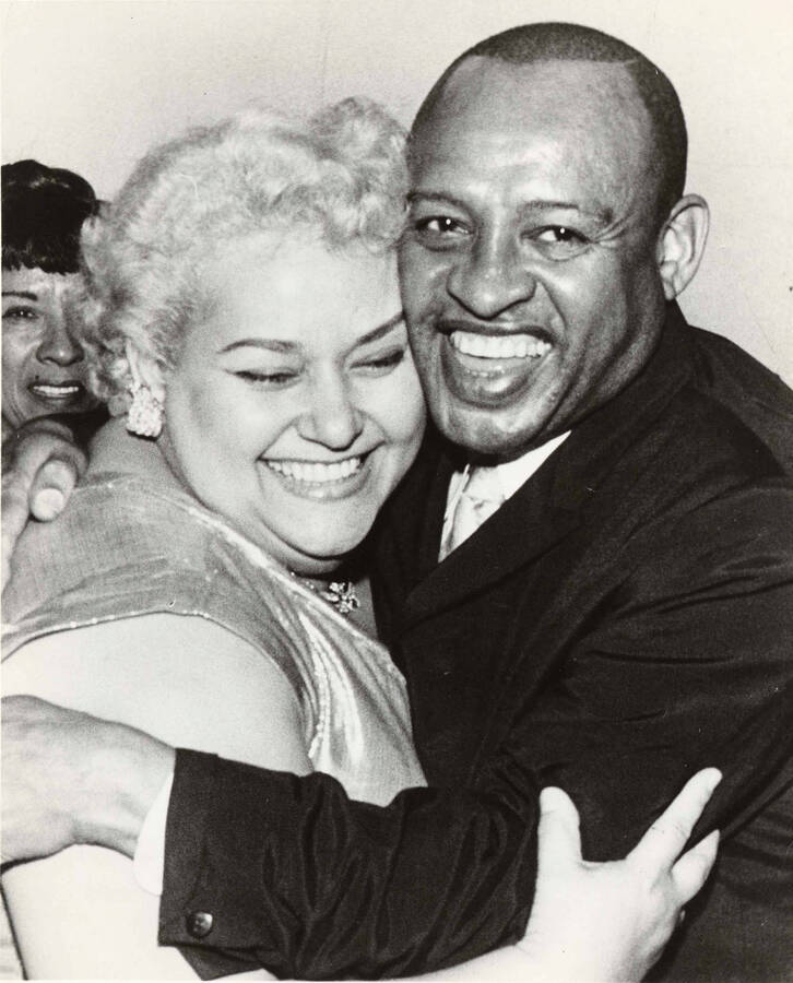 10 x 8 inch photograph. Lionel Hampton with unidentified woman, observed by Gladys Hampton