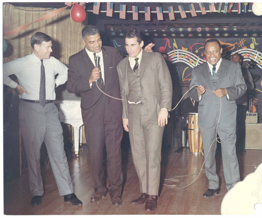 8 x 10 inch photograph. Lionel Hampton with Whitney Moore Young Jr. and two unidentified men