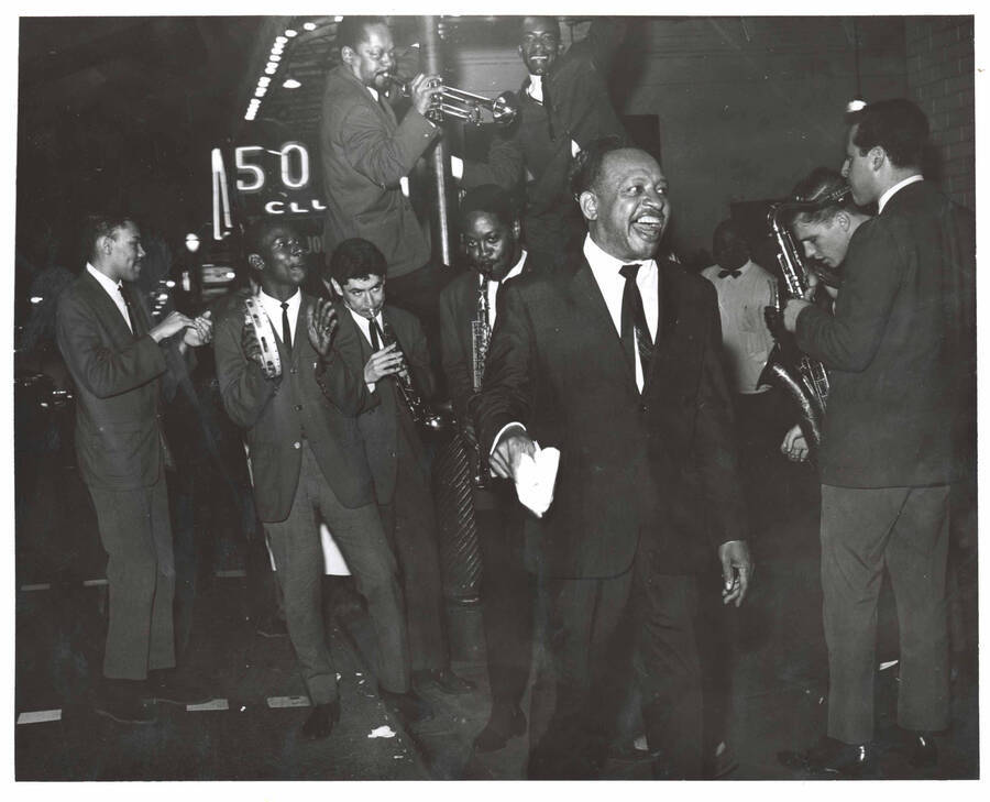 8 x 10 inch photograph. Lionel Hampton with band in front of Al Hirt's New Orleans Bourbon street nightclub. Seen on the background is the marquee of the 500 Club