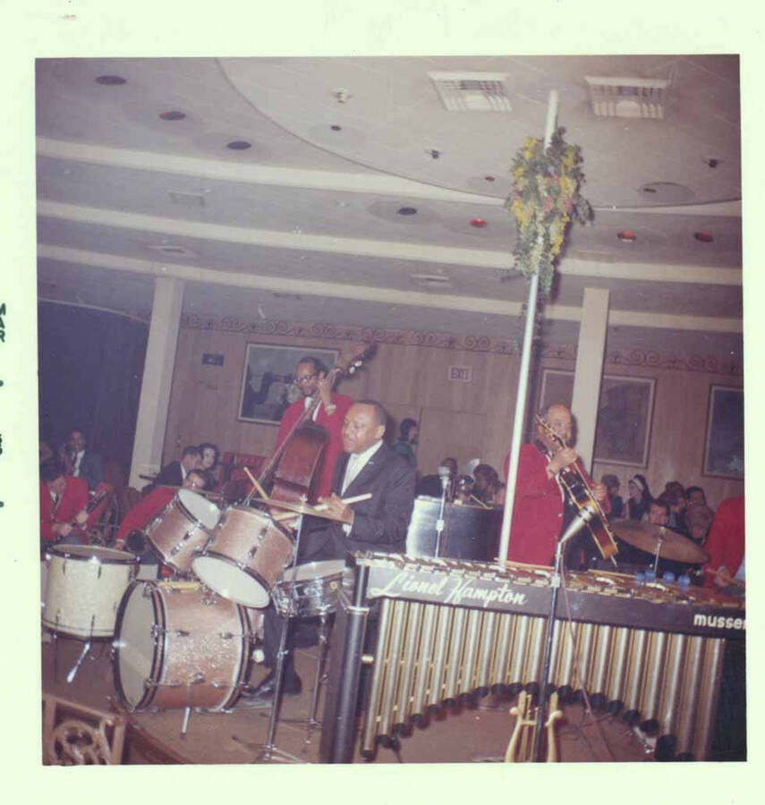 3 1/2 x 3 1/2 inch photograph. Lionel Hampton on drums with band [at Al Hirt's New Orleans Bourbon street nightclub]