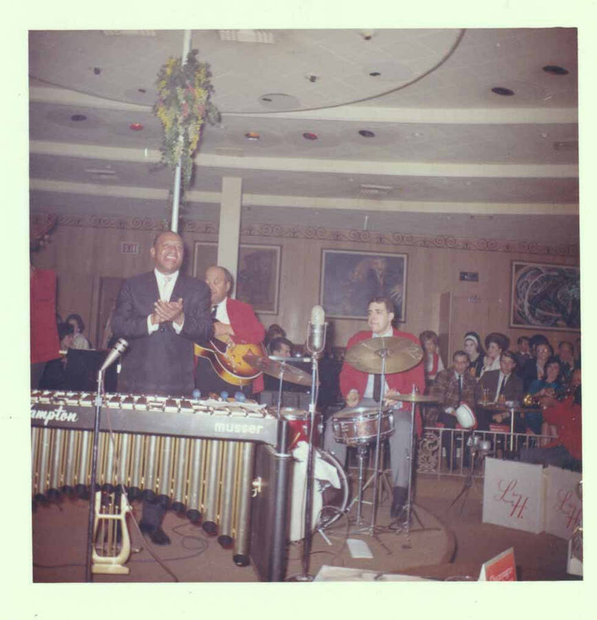 3 1/2 x 3 1/2 inch photograph. Lionel Hampton on vibraphone with band, which includes guitarist Billy Mackel, [at Al Hirt's New Orleans Bourbon street nightclub]