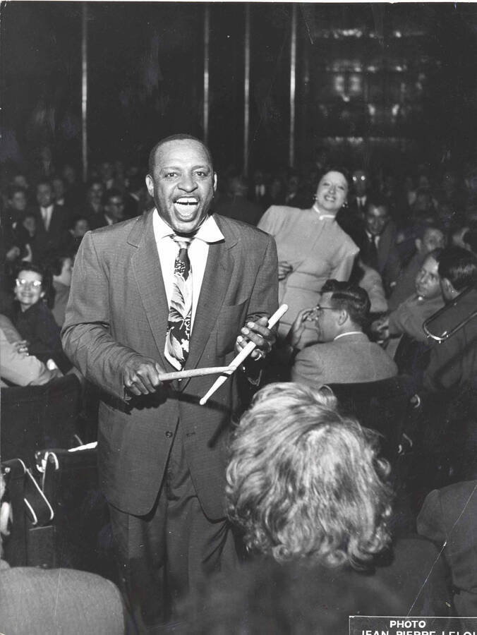 9 1/2 x 7 inch photograph. Lionel Hampton holding drumsticks, among audience