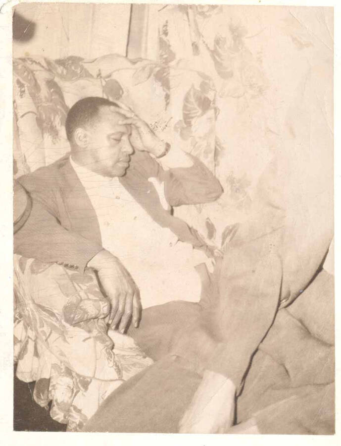 4 x 3 inch photograph. Lionel Hampton resting on a chair