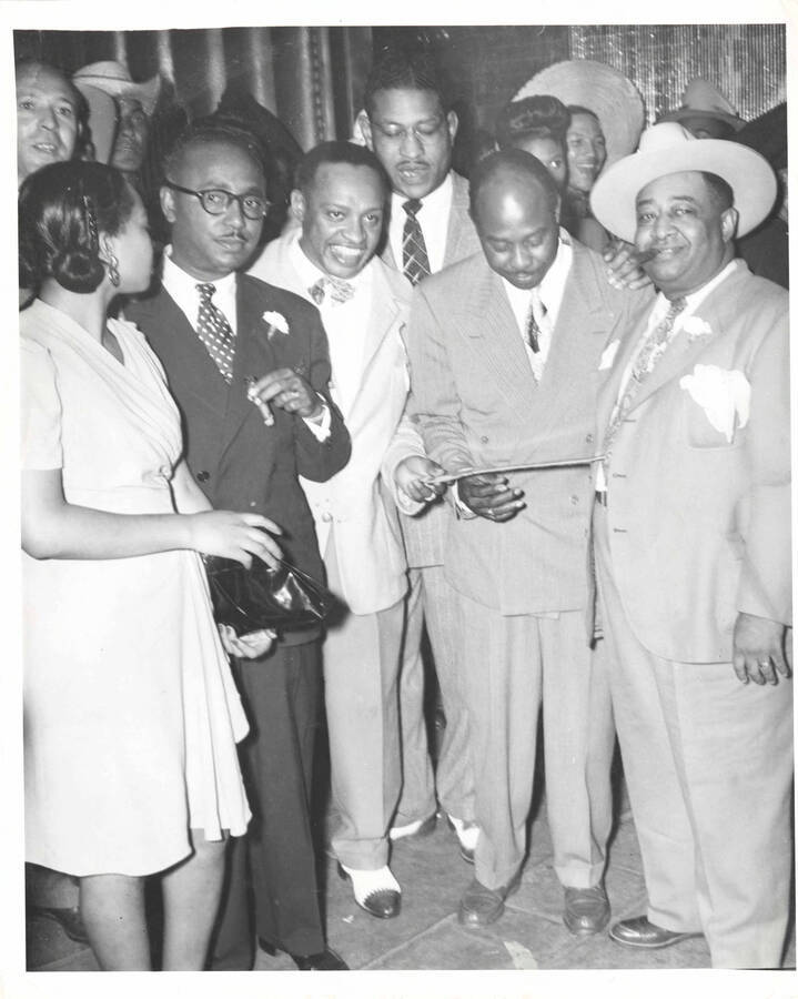 10 x 8 inch photograph. Lionel Hampton and Roy Milton holding a ceremonial key with unidentified persons