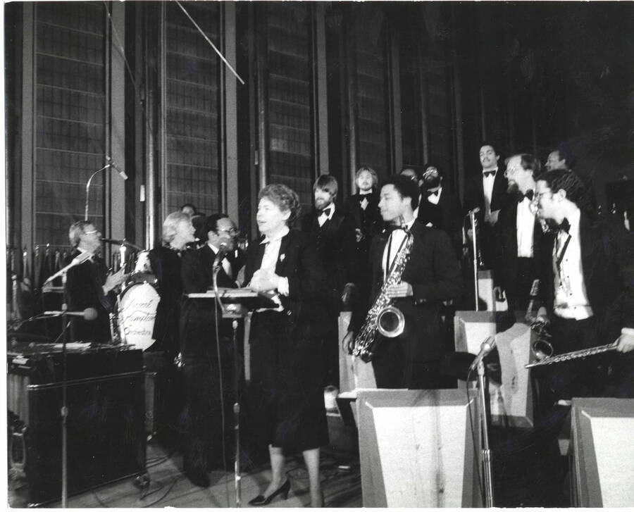 8 x 10 inch photograph. Lionel Hampton,  Jeane Jordan Kirkpatrick, and orchestra, on the occasion of his receiving a plaque from the United States Mission that appointed him as Ambassador of Music to the United Nations
