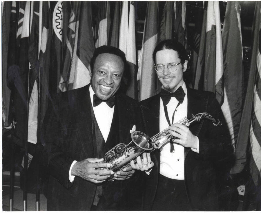 8 x 10 inch photograph. Lionel Hampton with unidentified saxophonist, on the occasion of his receiving a plaque from the United States Mission that appointed him as Ambassador of Music to the United Nations