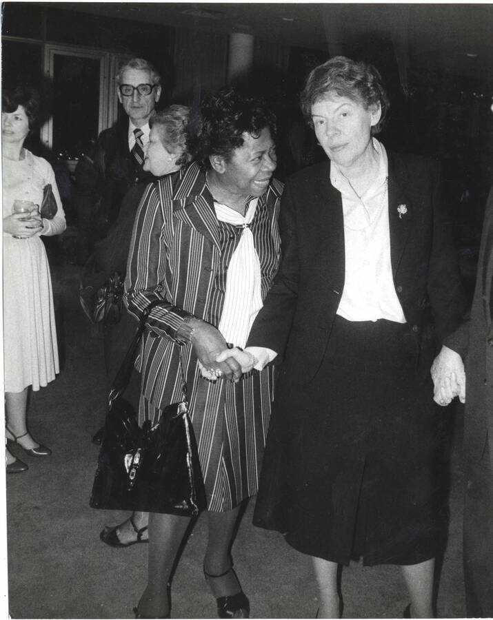 10 x 8 inch photograph. Jeane Jordan Kirkpatrick with unidentified woman on the occasion of Lionel Hampton receiving a plaque from the United States Mission that appointed him as Ambassador of Music to the United Nations