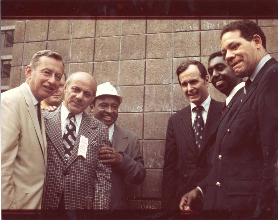 8 x 10 inch photograph. From left to right: Malcolm Wilson, Lionel Hampton, George Bush, and Andrew Young at the Grand Opening of the Lionel Hampton Houses