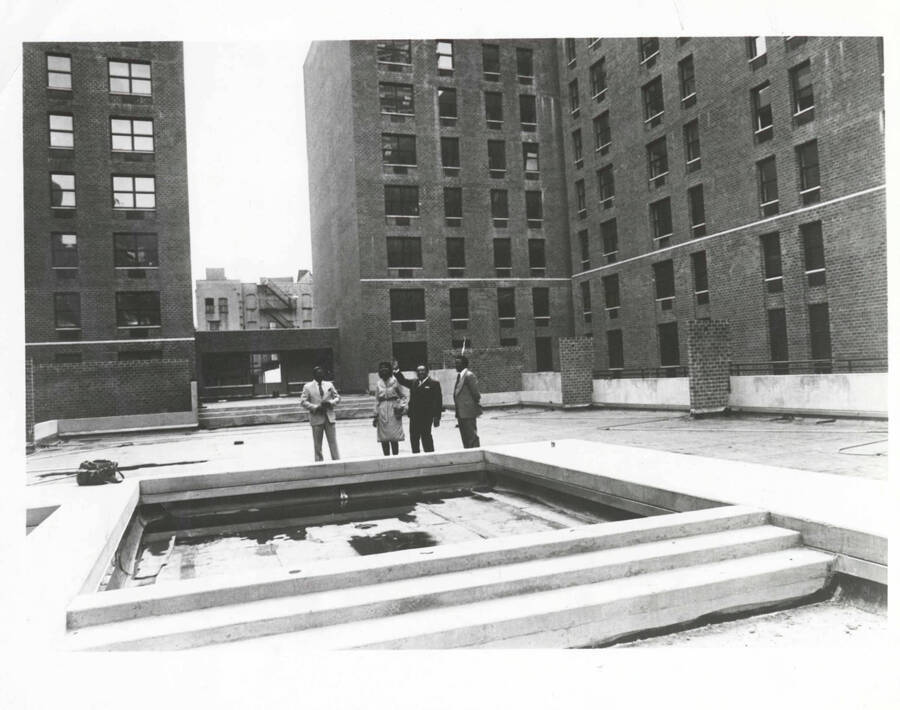 8 x 10 inch photograph. Lionel Hampton with unidentified persons [at the site of Lionel Hampton Houses]