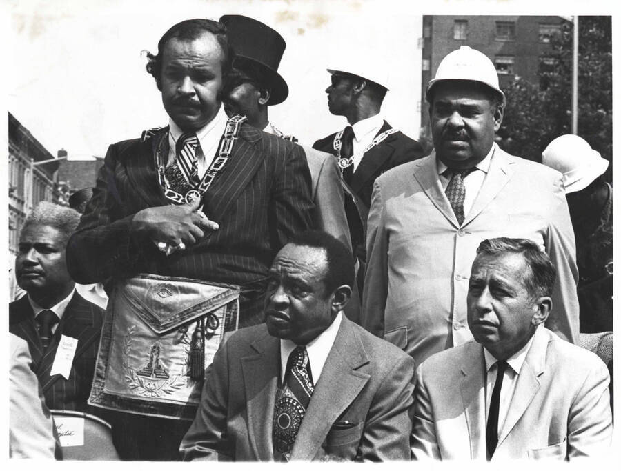 8 x 10 inch photograph. Lionel Hampton with lieutenant governor of New York,Malcolm Wilson and Ossie Davis, sitting on the left, at the Grand Opening of Lionel Hampton Houses