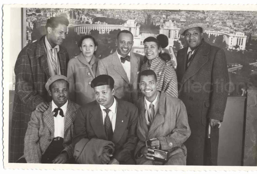 3 1/2 x 5 1/2 inch photograph in the format of postcard. A group photograph with Lionel and Gladys Hampton, Curley Hamner, Leo Moore, and others