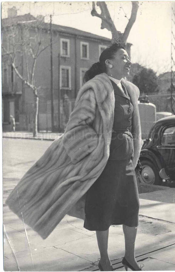 7 x 4 1/2 inch photograph. Gladys Hampton walking down a street [in France?]