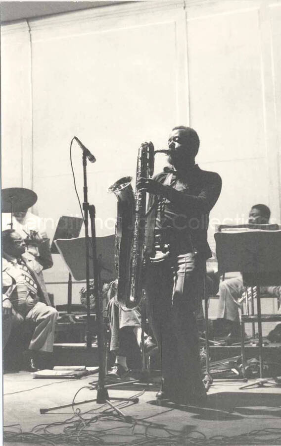 6 1/2 x 4 1/4 inch photograph. Lionel Hampton's band. Unidentified saxophonist