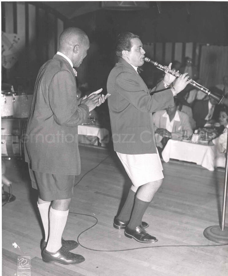 10 x 8 inch photograph. Lionel Hampton with unidentified clarinetist, in a restaurant