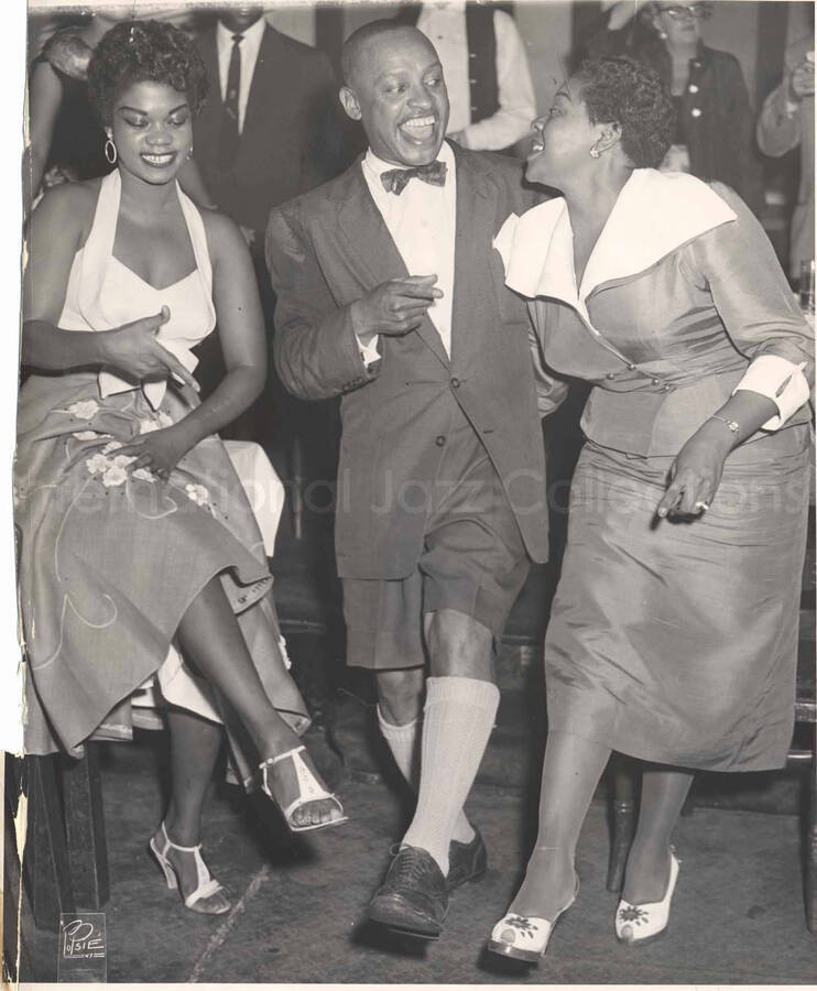 10 x 8 inch photograph. Lionel Hampton with [Dinah Washington] and unidentified woman, in a restaurant