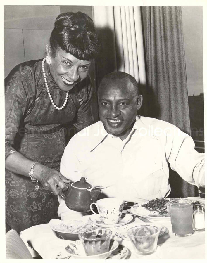 10 x 8 inch photograph. Gladys and Lionel Hampton having breakfast [abroad?]