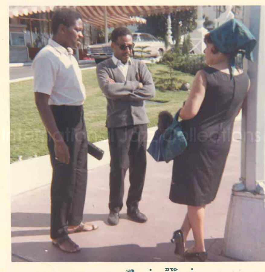 Gladys Hampton with unidentified men. 3 1/2 x 3 1/2 inch photograph.