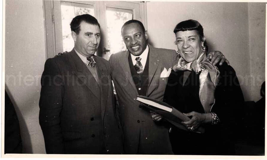 5 x 8 inch photograph. Gladys and Lionel Hampton with band in Israel. Gladys and Lionel Hampton with unidentified man
