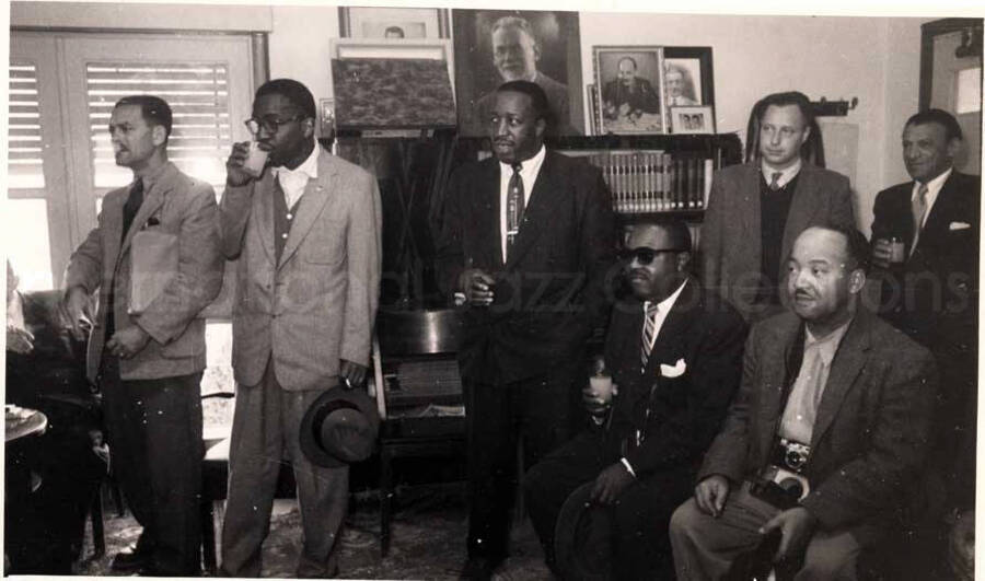 5 x 8 inch photograph. Gladys and Lionel Hampton with band in Israel. Members of the Lionel Hampton's band, which includes Billy Mackel, with unidentified men