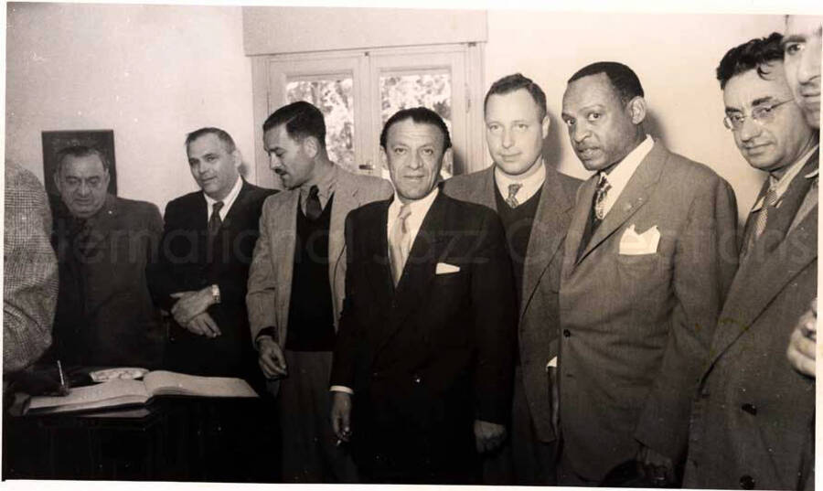 5 x 8 inch photograph. Gladys and Lionel Hampton with band in Israel. Lionel Hampton with unidentified men