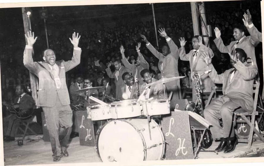 5 x 8 inch photograph. Lionel Hampton performing with band in Israel. Members of the band, which includes guitarist Billy Mackel