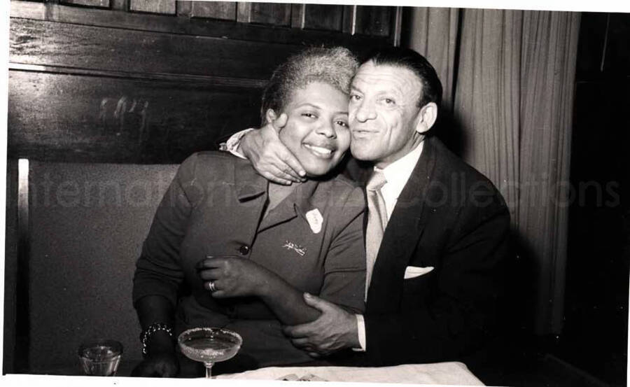 5 x 8 inch photograph. Vocalist of Lionel Hampton's band with unidentified man in a restaurant in Israel