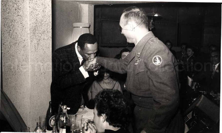 5 x 8 inch photograph. Lionel Hampton with unidentified persons in a restaurant in Israel