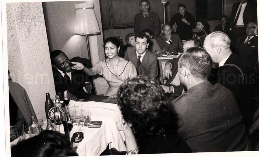 5 x 8 inch photograph. Lionel Hampton with unidentified persons in a restaurant in Israel